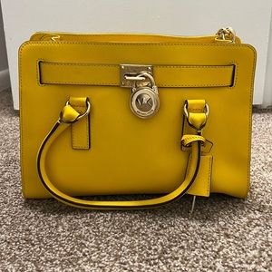Vibrant yellow mustard Michael Kors bag with gold hardware